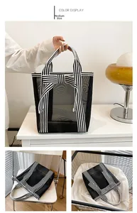 Medium size black mesh tote bag with striped canvas handles and bow detail for daily use