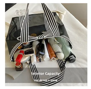 Top view of large black mesh tote bag showing spacious interior with various essentials