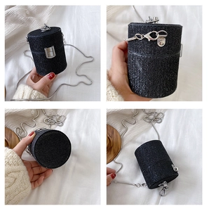 Detail views of mini black rhinestone cylinder bag with silver chain and metal clasp