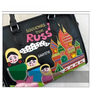 Detail of Russian doll embroidery and St. Basil Cathedral on black tote bag