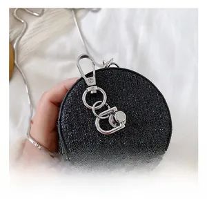 Detailed close-up of a mini round sequin bag with silver chain and metal hook