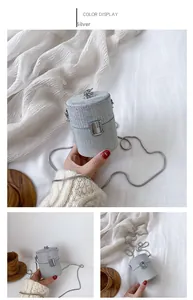 Detail of silver cylindrical mini evening bag with glitter finish and metal chain