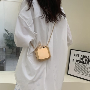 Fashionable gold geometric box bag with chain strap shown on model for sizing