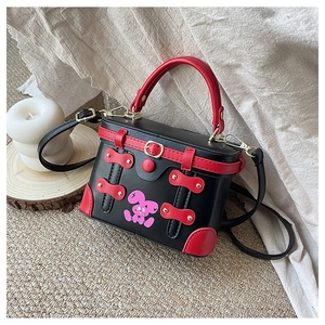 Detail view of retro box bag with contrast red trim and a pink cartoon bunny print