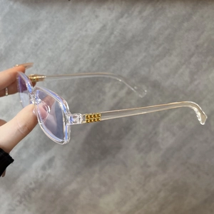 Detailed view of square blue light blocking glasses with gold rivet hinge accents