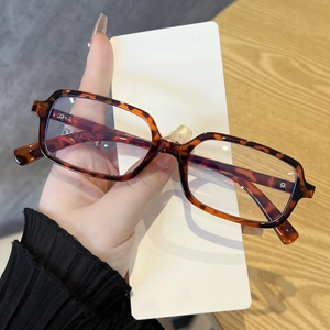 Detail of tortoise shell rectangular frame with silver metal cross screw hinges