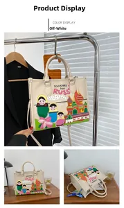 Detail view of cream tote bag with Russian souvenir prints and cathedral graphics