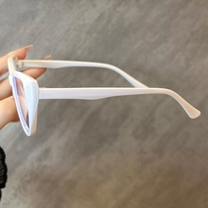Close-up of white cat-eye glasses frame side temple and hinge detail construction