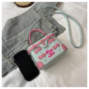 Detailed top view of a mini blue and pink crossbody bag with a cute rabbit design