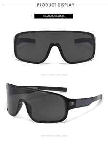 Close-up of black shield sunglasses showing the seamless lens and futuristic sport frame