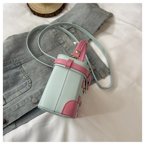 Detail view of mini contrast barrel bag featuring pink and blue leather with gold studs