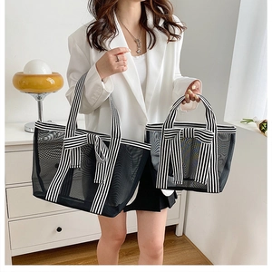 Detail of black mesh tote bags in two sizes with stylish striped bow handles and trim