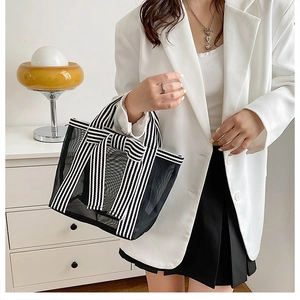 Detail of transparent mesh tote bag with striped ribbon bow accent in minimalist style