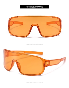Close-up of orange cycling sunglasses with integrated frame and tinted lenses