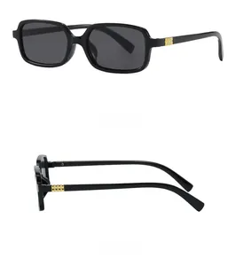 Detail view of square black sunglasses featuring gold metal accents on the temples