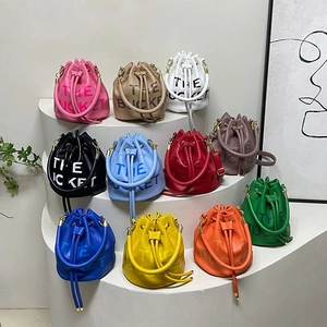Fashionable drawstring bucket bags in multiple colors with textured leather and bold lettering