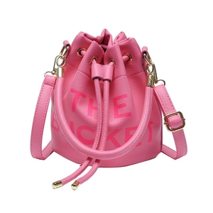Pink drawstring bucket bag in pebble leather with THE BUCKET print and gold hardware