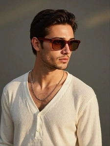 Close-up of men's retro square brown sunglasses paired with a textured cream knit cardigan