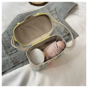 Interior view of small crossbody bag showing space for a cushion and small umbrella