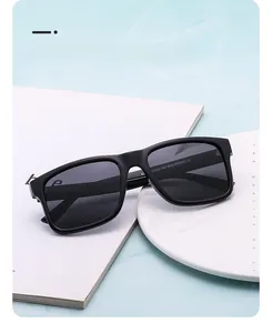Detail of black polarized sunglasses with matte frame shown on a marble background