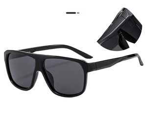 Close-up of large black polarized sunglasses with CE mark and hinge detail view