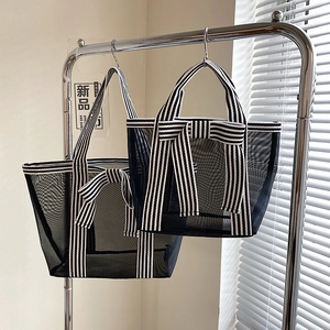 Minimalist mesh tote bag with black and white stripes and bow detail for summer