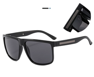 Close-up of polarized sunglasses showing the metal hinge detail and sleek black frame