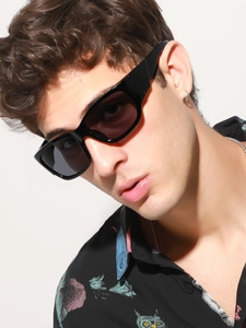 Close-up of sporty black rectangular polarized sunglasses worn by a male model