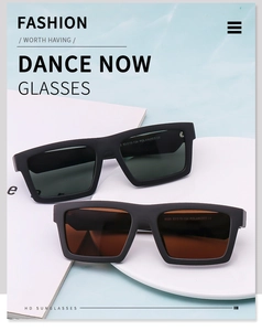 Close-up of polarized square sunglasses with matte black frames and color-tinted lenses
