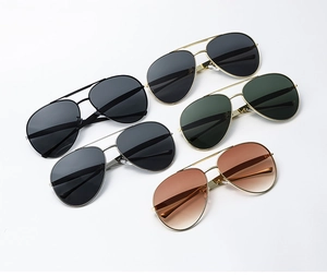 Flat lay macro view of five aviator sunglasses with metal frames in various colors