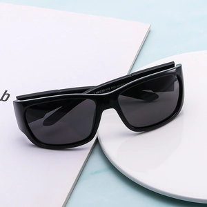 Polarized black square frame sports sunglasses for men on a minimalist blue marble surface
