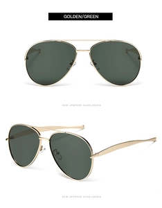 Detail view of classic golden metal pilot sunglasses with dark green lenses and double bridge