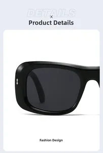 Close-up of black oversized sunglasses with silver bow-tie metal temple detailing