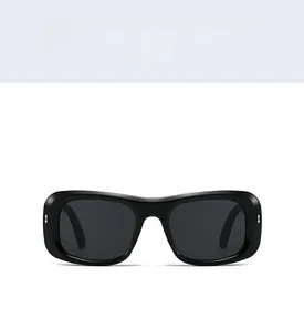 Front view of black square frame sunglasses with silver metal studs and dark grey lenses