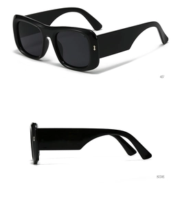Detail view of wide-leg black sunglasses featuring side metal accents and bold frames