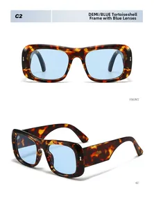 Detail view of large tortoise frame sunglasses with blue lenses and silver accents