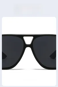Detail view of stylish double-bridge black frame sunglasses with sleek dark lenses