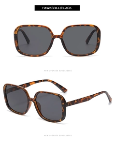 Detail view of large hawksbill pattern frames with black lenses and metal hinges