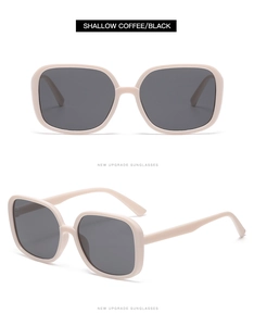 Detail view of large square shallow coffee sunglasses with thick frames and dark lenses