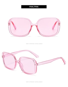 Close-up of pink oversized square sunglasses with transparent frames and matching lenses