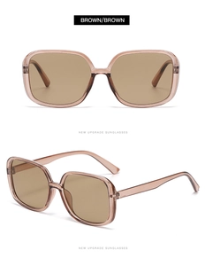 Close-up of brown oversized square sunglasses featuring translucent resin frames and lenses
