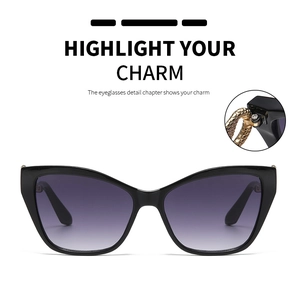 Close-up of golden snake-shaped metal temple detail on stylish cat-eye sunglasses