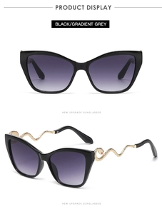 Detailed view of cat-eye sunglasses featuring golden snake-shaped metal temples and grey lenses