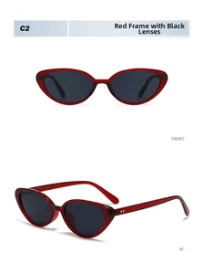 Dettaglio di occhiali da sole cat-eye rossi con lenti grigie e rivetti in argento
