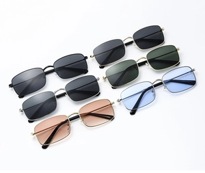 Flat lay of vintage rectangular metal sunglasses in various lens colors and frames
