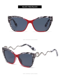 Detail view of cat eye sunglasses with silver snake temples and red leopard frame