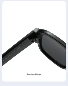 Macro view of durable metal hinge connection on glossy black oversized sunglasses frame