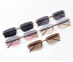 Detail view of five rimless rectangle sunglasses with spike textured gold metal temples