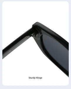 Detailed macro view of sturdy metal hinge on black cat-eye sunglasses for women