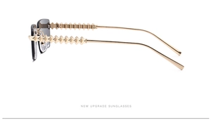 Detail of gold metal temples with pyramid stud pattern on rimless sunglasses